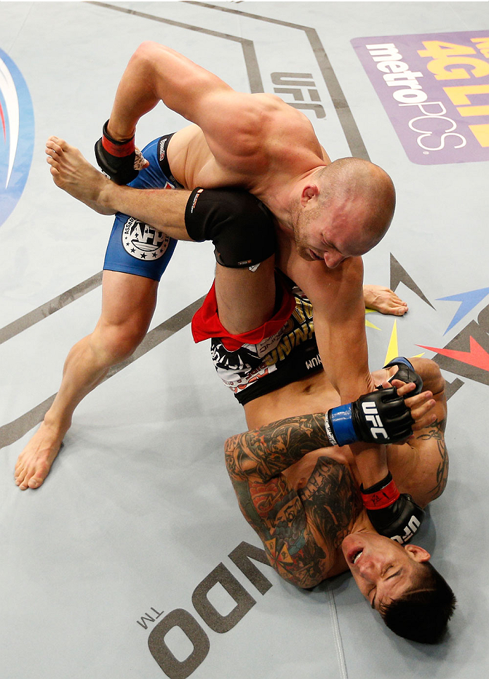 ALBUQUERQUE, NM - JUNE 07: (L-R) Patrick Cummins punches Roger Narvaez in their light heavyweight fight during the UFC Fight Night event at Tingley Coliseum on June 7, 2014 in Albuquerque, New Mexico. (Photo by Josh Hedges/Zuffa LLC/Zuffa LLC via Getty