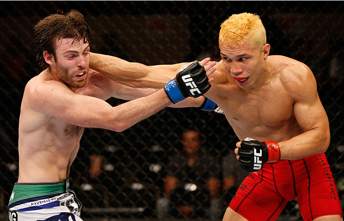 ALBUQUERQUE, NM - JUNE 07:  (R-L) Jon Tuck punches Jake Lindsey in their lightweight fight during the UFC Fight Night event at Tingley Coliseum on June 7, 2014 in Albuquerque, New Mexico.  (Photo by Josh Hedges/Zuffa LLC/Zuffa LLC via Getty Images)