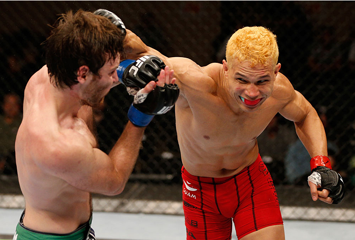 ALBUQUERQUE, NM - JUNE 07:  (R-L) Jon Tuck punches Jake Lindsey in their lightweight fight during the UFC Fight Night event at Tingley Coliseum on June 7, 2014 in Albuquerque, New Mexico.  (Photo by Josh Hedges/Zuffa LLC/Zuffa LLC via Getty Images)