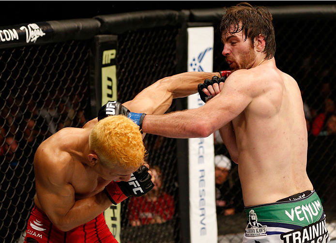 ALBUQUERQUE, NM - JUNE 07:  (R-L) Jake Lindsey and Jon Tuck trade punches in their lightweight fight during the UFC Fight Night event at Tingley Coliseum on June 7, 2014 in Albuquerque, New Mexico.  (Photo by Josh Hedges/Zuffa LLC/Zuffa LLC via Getty Imag