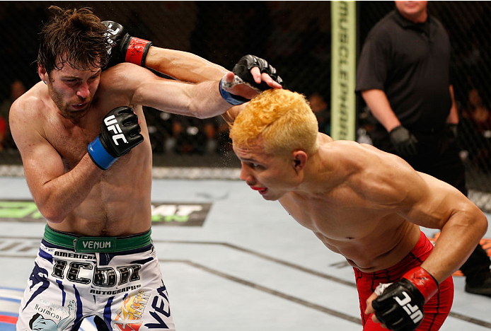 ALBUQUERQUE, NM - JUNE 07:  (R-L) Jon Tuck punches Jake Lindsey in their lightweight fight during the UFC Fight Night event at Tingley Coliseum on June 7, 2014 in Albuquerque, New Mexico.  (Photo by Josh Hedges/Zuffa LLC/Zuffa LLC via Getty Images)