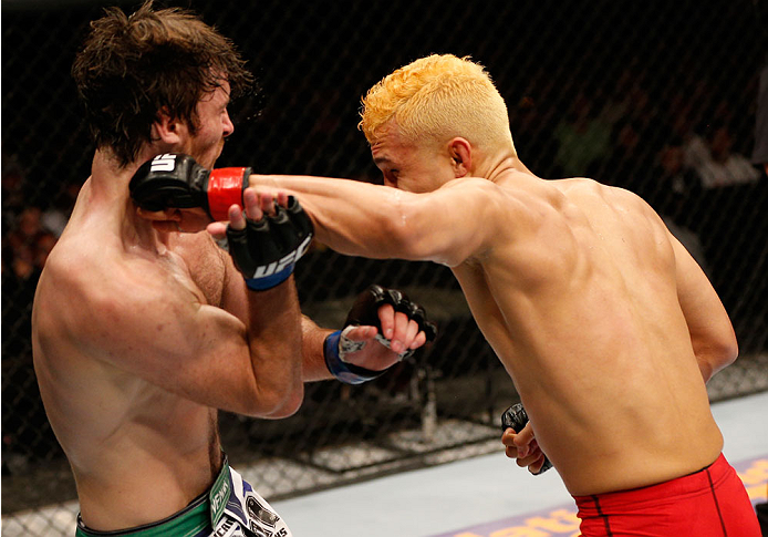 ALBUQUERQUE, NM - JUNE 07:  (R-L) Jon Tuck punches Jake Lindsey in their lightweight fight during the UFC Fight Night event at Tingley Coliseum on June 7, 2014 in Albuquerque, New Mexico.  (Photo by Josh Hedges/Zuffa LLC/Zuffa LLC via Getty Images)