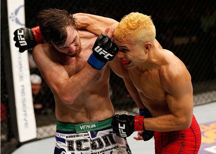 ALBUQUERQUE, NM - JUNE 07:  (R-L) Jon Tuck punches Jake Lindsey in their lightweight fight during the UFC Fight Night event at Tingley Coliseum on June 7, 2014 in Albuquerque, New Mexico.  (Photo by Josh Hedges/Zuffa LLC/Zuffa LLC via Getty Images)