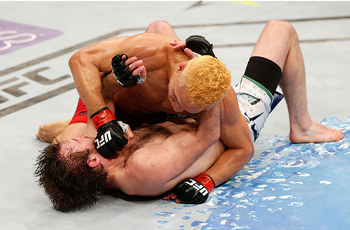 ALBUQUERQUE, NM - JUNE 07:  (R-L) Jon Tuck punches Jake Lindsey in their lightweight fight during the UFC Fight Night event at Tingley Coliseum on June 7, 2014 in Albuquerque, New Mexico.  (Photo by Josh Hedges/Zuffa LLC/Zuffa LLC via Getty Images)