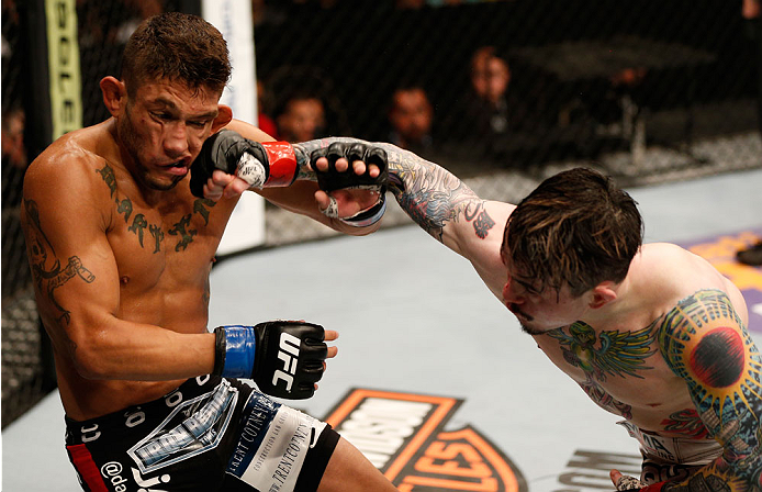 ALBUQUERQUE, NM - JUNE 07:  (R-L) Scott Jorgensen punches Danny Martinez in their flyweight fight during the UFC Fight Night event at Tingley Coliseum on June 7, 2014 in Albuquerque, New Mexico.  (Photo by Josh Hedges/Zuffa LLC/Zuffa LLC via Getty Images)