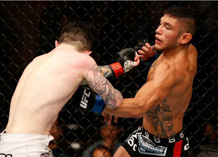 ALBUQUERQUE, NM - JUNE 07:  (R-L) Danny Martinez punches Scott Jorgensen in their flyweight fight during the UFC Fight Night event at Tingley Coliseum on June 7, 2014 in Albuquerque, New Mexico.  (Photo by Josh Hedges/Zuffa LLC/Zuffa LLC via Getty Images)