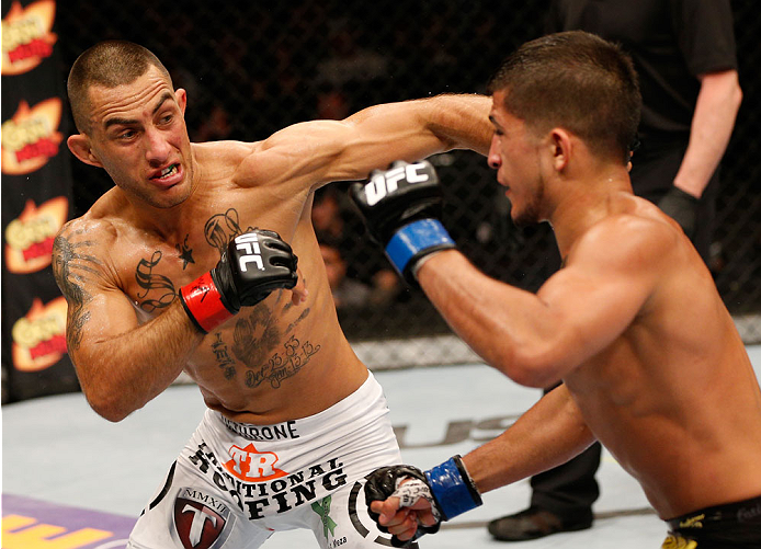 ALBUQUERQUE, NM - JUNE 07:  (L-R) Yaotzin Meza punches Sergio Pettis in their bantamweight fight during the UFC Fight Night event at Tingley Coliseum on June 7, 2014 in Albuquerque, New Mexico.  (Photo by Josh Hedges/Zuffa LLC/Zuffa LLC via Getty Images)