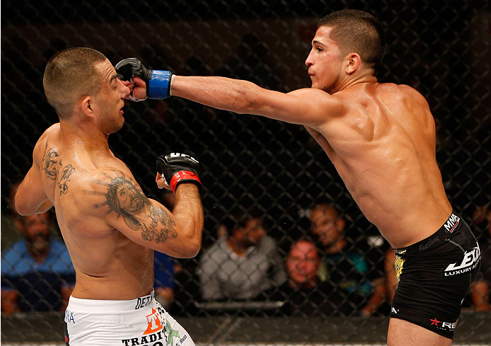 ALBUQUERQUE, NM - JUNE 07:  (R-L) Sergio Pettis punches Yaotzin Meza in their bantamweight fight during the UFC Fight Night event at Tingley Coliseum on June 7, 2014 in Albuquerque, New Mexico.  (Photo by Josh Hedges/Zuffa LLC/Zuffa LLC via Getty Images)