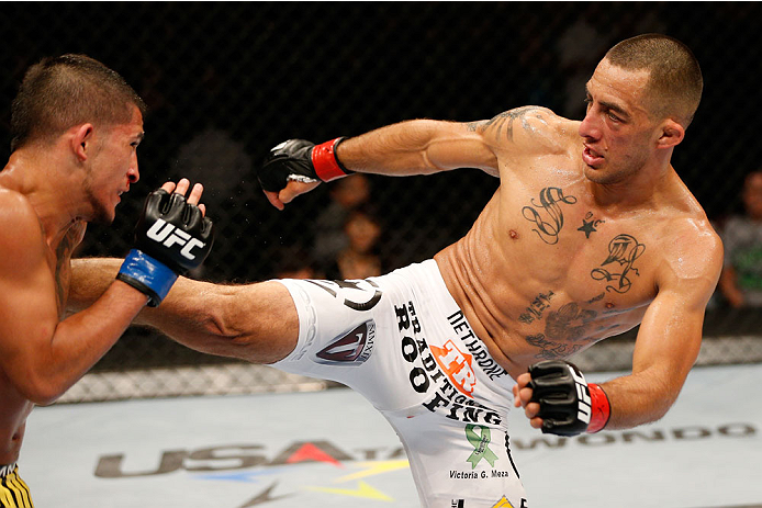 ALBUQUERQUE, NM - JUNE 07:  (R-L) Yaotzin Meza kicks Sergio Pettis in their bantamweight fight during the UFC Fight Night event at Tingley Coliseum on June 7, 2014 in Albuquerque, New Mexico.  (Photo by Josh Hedges/Zuffa LLC/Zuffa LLC via Getty Images)