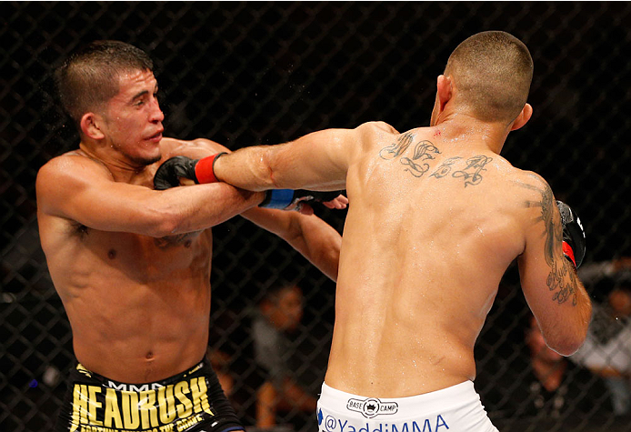 ALBUQUERQUE, NM - JUNE 07:  (R-L) Yaotzin Meza punches Sergio Pettis in their bantamweight fight during the UFC Fight Night event at Tingley Coliseum on June 7, 2014 in Albuquerque, New Mexico.  (Photo by Josh Hedges/Zuffa LLC/Zuffa LLC via Getty Images)