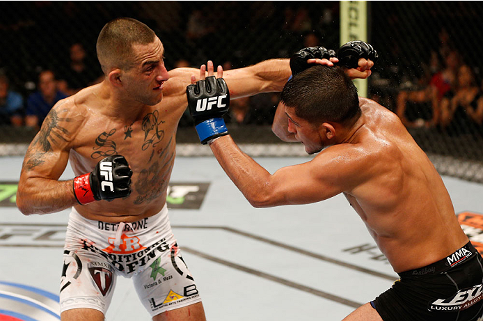 ALBUQUERQUE, NM - JUNE 07:  (L-R) Yaotzin Meza punches Sergio Pettis in their bantamweight fight during the UFC Fight Night event at Tingley Coliseum on June 7, 2014 in Albuquerque, New Mexico.  (Photo by Josh Hedges/Zuffa LLC/Zuffa LLC via Getty Images)