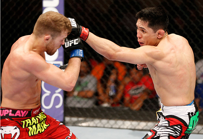 ALBUQUERQUE, NM - JUNE 07:  (R-L) Erik Perez punches Bryan Caraway in their bantamweight fight during the UFC Fight Night event at Tingley Coliseum on June 7, 2014 in Albuquerque, New Mexico.  (Photo by Josh Hedges/Zuffa LLC/Zuffa LLC via Getty Images)