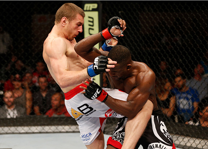 ALBUQUERQUE, NM - JUNE 07:  (L-R) Piotr Hallmann knees Yves Edwards in their lightweight fight during the UFC Fight Night event at Tingley Coliseum on June 7, 2014 in Albuquerque, New Mexico.  (Photo by Josh Hedges/Zuffa LLC/Zuffa LLC via Getty Images)