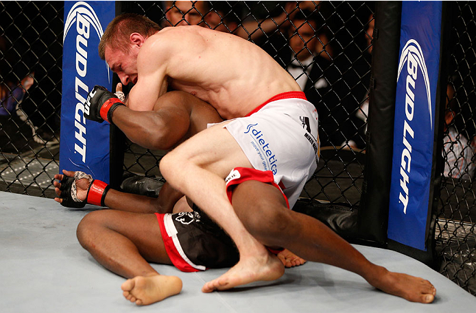 ALBUQUERQUE, NM - JUNE 07: (R-L) Piotr Hallmann secures a rear choke submission against Yves Edwards in their lightweight fight during the UFC Fight Night event at Tingley Coliseum on June 7, 2014 in Albuquerque, New Mexico. (Photo by Josh Hedges/Zuffa