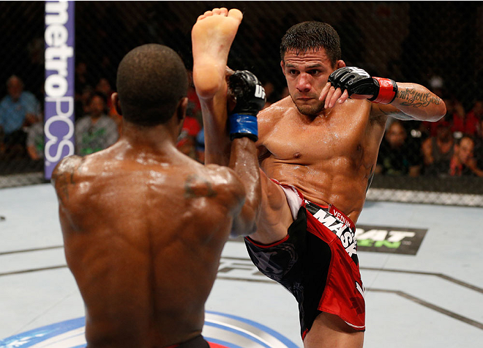 ALBUQUERQUE, NM - JUNE 07:  (R-L) Rafael Dos Anjos kicks Jason High in their lightweight fight during the UFC Fight Night event at Tingley Coliseum on June 7, 2014 in Albuquerque, New Mexico.  (Photo by Josh Hedges/Zuffa LLC/Zuffa LLC via Getty Images)