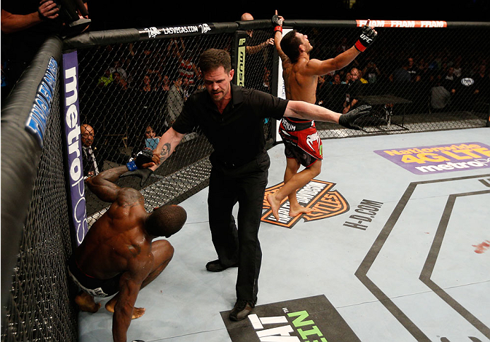 ALBUQUERQUE, NM - JUNE 07:  Referee Kevin Mulhall stops the bout as Rafael Dos Anjos (R) defeats Jason High (L) by TKO in their lightweight fight during the UFC Fight Night event at Tingley Coliseum on June 7, 2014 in Albuquerque, New Mexico.  (Photo by J