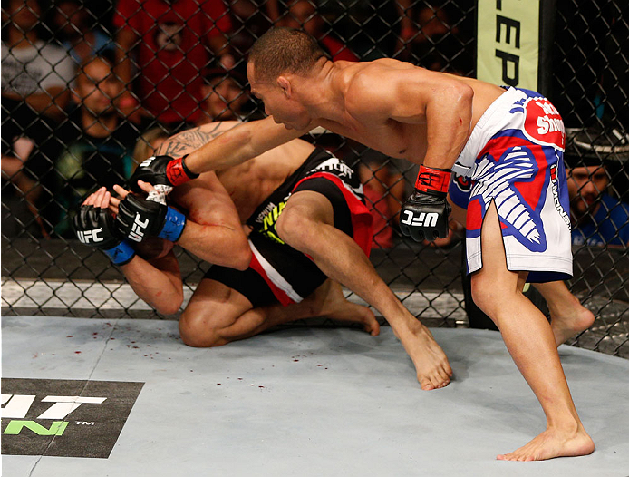 ALBUQUERQUE, NM - JUNE 07:  (R-L) John Dodson punches John Moraga in their flyweight fight during the UFC Fight Night event at Tingley Coliseum on June 7, 2014 in Albuquerque, New Mexico.  (Photo by Josh Hedges/Zuffa LLC/Zuffa LLC via Getty Images)