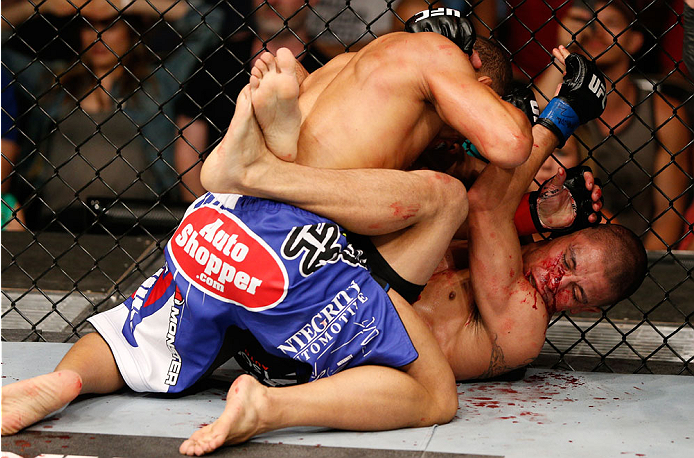 ALBUQUERQUE, NM - JUNE 07:  (L-R) John Dodson elbows John Moraga in their flyweight fight during the UFC Fight Night event at Tingley Coliseum on June 7, 2014 in Albuquerque, New Mexico.  (Photo by Josh Hedges/Zuffa LLC/Zuffa LLC via Getty Images)