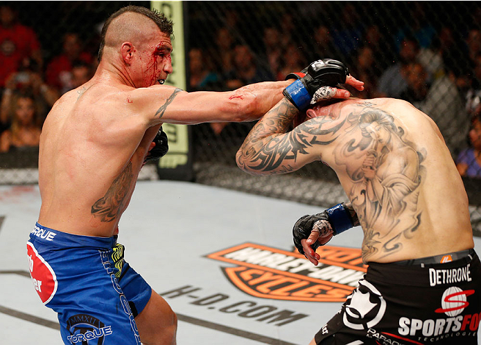 ALBUQUERQUE, NM - JUNE 07:  (L-R) Diego Sanchez punches Ross Pearson in their lightweight fight during the UFC Fight Night event at Tingley Coliseum on June 7, 2014 in Albuquerque, New Mexico.  (Photo by Josh Hedges/Zuffa LLC/Zuffa LLC via Getty Images)