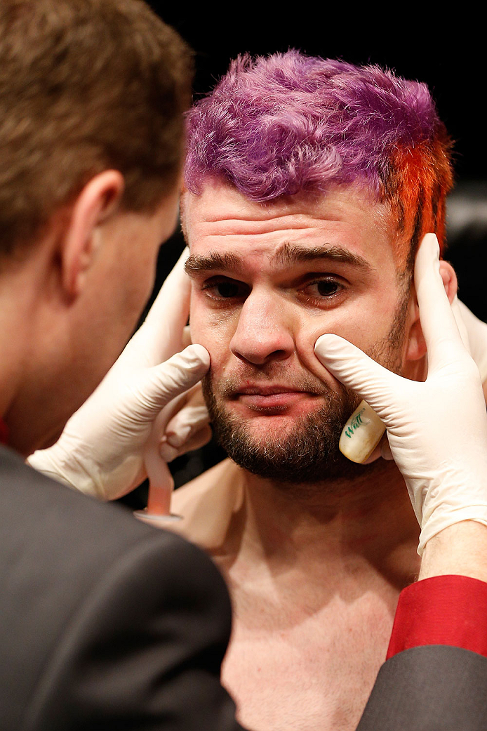 BRISBANE, AUSTRALIA - DECEMBER 07: Ben Wall is checked by a doctor after his knockout loss to Alex Garcia in their welterweight fight during the UFC Fight Night event at the Brisbane Entertainment Centre on December 7, 2013 in Brisbane, Australia. (Photo