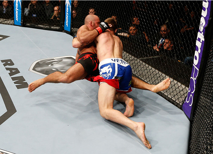 BRISBANE, AUSTRALIA - DECEMBER 07: (R-L) Krzysztof Jotko takes down Bruno Santos in their middleweight fight during the UFC Fight Night event at the Brisbane Entertainment Centre on December 7, 2013 in Brisbane, Australia. (Photo by Josh Hedges/Zuffa LLC