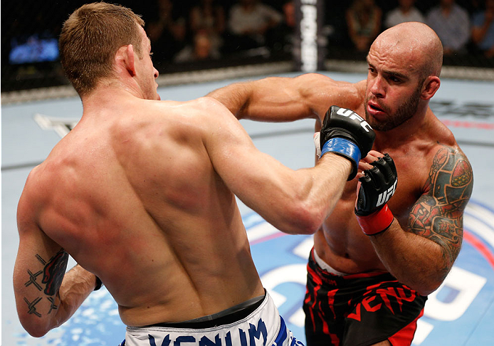 BRISBANE, AUSTRALIA - DECEMBER 07: (R-L) Bruno Santos and Krzysztof Jotko trade punches in their middleweight fight during the UFC Fight Night event at the Brisbane Entertainment Centre on December 7, 2013 in Brisbane, Australia. (Photo by Josh Hedges/Zu