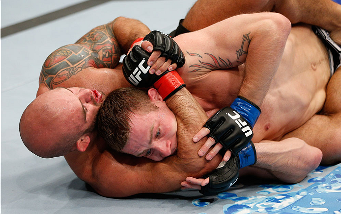 BRISBANE, AUSTRALIA - DECEMBER 07: (L-R) Bruno Santos attempts to secure a rear choke submission against Krzysztof Jotko in their middleweight fight during the UFC Fight Night event at the Brisbane Entertainment Centre on December 7, 2013 in Brisbane, Au
