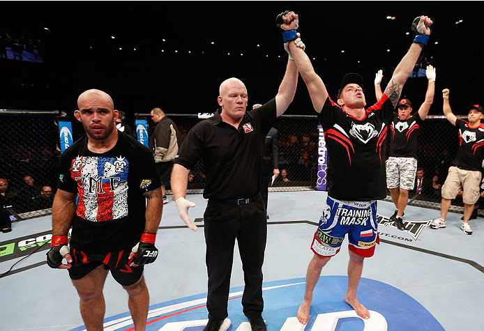 BRISBANE, AUSTRALIA - DECEMBER 07: Krzysztof Jotko (R) reacts after his decision victory over Bruno Santos (L) in their middleweight fight during the UFC Fight Night event at the Brisbane Entertainment Centre on December 7, 2013 in Brisbane, Australia. (