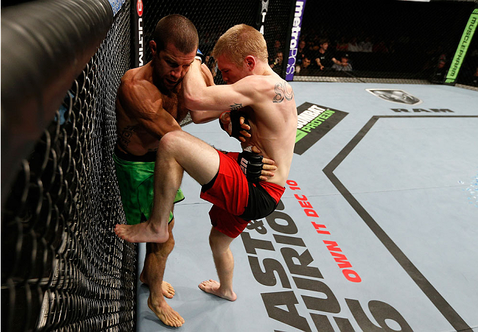 BRISBANE, AUSTRALIA - DECEMBER 07: (R-L) Justin Scoggins knees Richie Vaculik in their flyweight fight during the UFC Fight Night event at the Brisbane Entertainment Centre on December 7, 2013 in Brisbane, Australia. (Photo by Josh Hedges/Zuffa LLC/Zuffa