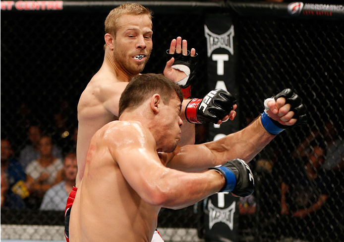 BRISBANE, AUSTRALIA - DECEMBER 07: (L-R) Nick Ring punches Caio Magalhaes in their middleweight fight during the UFC Fight Night event at the Brisbane Entertainment Centre on December 7, 2013 in Brisbane, Australia. (Photo by Josh Hedges/Zuffa LLC/Zuffa