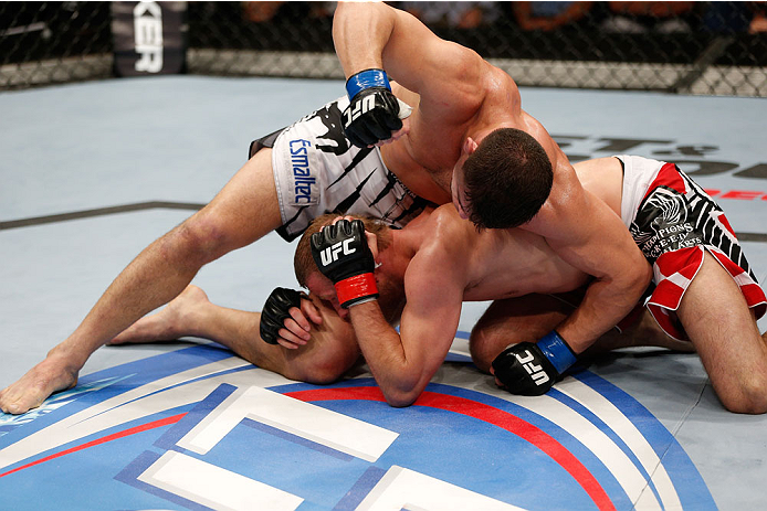 BRISBANE, AUSTRALIA - DECEMBER 07: (L-R) Caio Magalhaes punches Nick Ring in their middleweight fight during the UFC Fight Night event at the Brisbane Entertainment Centre on December 7, 2013 in Brisbane, Australia. (Photo by Josh Hedges/Zuffa LLC/Zuffa