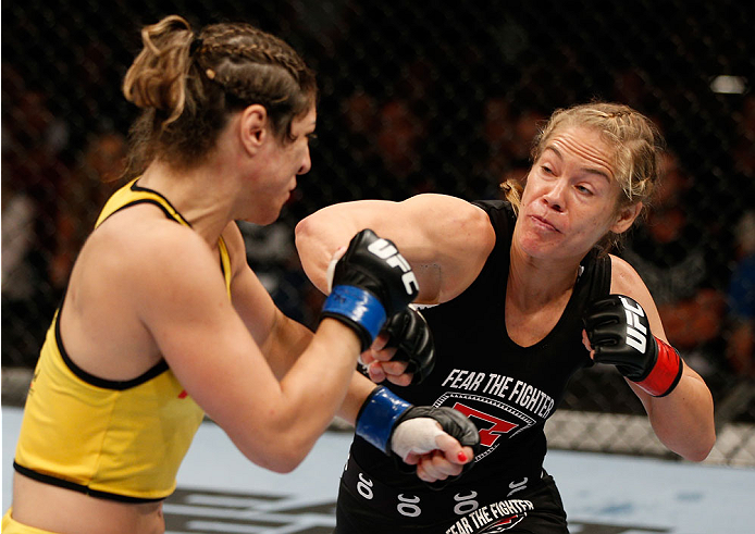BRISBANE, AUSTRALIA - DECEMBER 07: (R-L) Julie Kedzie punches Bethe Correia in their women's bantamweight fight during the UFC Fight Night event at the Brisbane Entertainment Centre on December 7, 2013 in Brisbane, Australia. (Photo by Josh Hedges/Zuffa