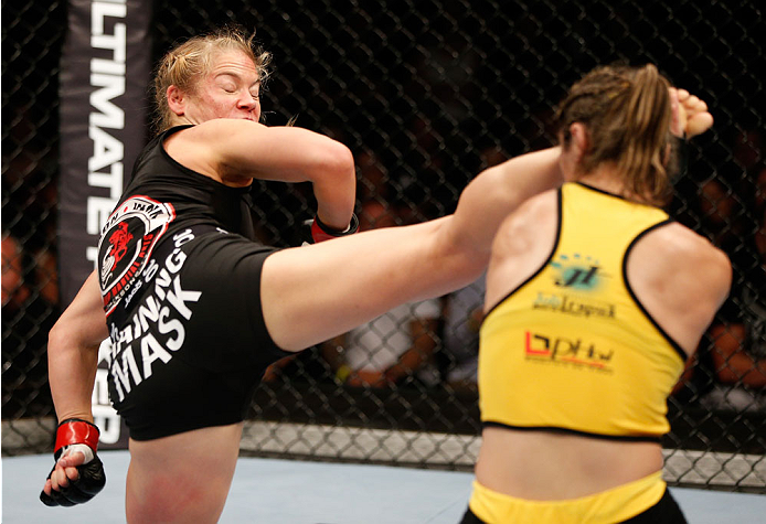 BRISBANE, AUSTRALIA - DECEMBER 07: (L-R) Julie Kedzie kicks Bethe Correia in their women's bantamweight fight during the UFC Fight Night event at the Brisbane Entertainment Centre on December 7, 2013 in Brisbane, Australia. (Photo by Josh Hedges/Zuffa LL