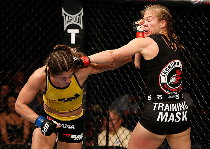 BRISBANE, AUSTRALIA - DECEMBER 07: (L-R) Bethe Correia and Julie Kedzie trade punches in their women's bantamweight fight during the UFC Fight Night event at the Brisbane Entertainment Centre on December 7, 2013 in Brisbane, Australia. (Photo by Josh Hed