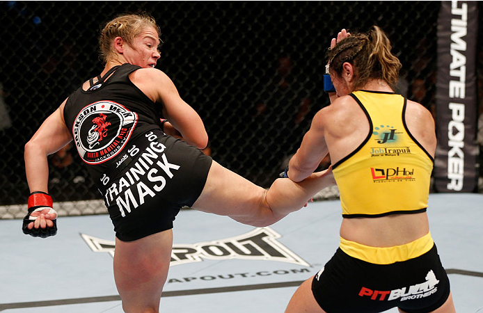BRISBANE, AUSTRALIA - DECEMBER 07: (L-R) Julie Kedzie kicks Bethe Correia in their women's bantamweight fight during the UFC Fight Night event at the Brisbane Entertainment Centre on December 7, 2013 in Brisbane, Australia. (Photo by Josh Hedges/Zuffa LL