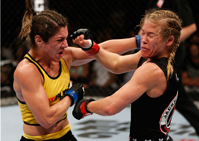 BRISBANE, AUSTRALIA - DECEMBER 07: (L-R) Bethe Correia punches Julie Kedzie in their women's bantamweight fight during the UFC Fight Night event at the Brisbane Entertainment Centre on December 7, 2013 in Brisbane, Australia. (Photo by Josh Hedges/Zuffa