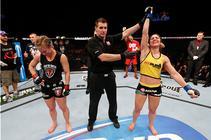 BRISBANE, AUSTRALIA - DECEMBER 07: Bethe Correia (R) reacts after defeating Julie Kedzie by split decision in their women's bantamweight fight during the UFC Fight Night event at the Brisbane Entertainment Centre on December 7, 2013 in Brisbane, Australi