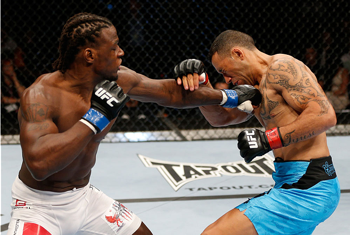 BRISBANE, AUSTRALIA - DECEMBER 07: (L-R) Clint Hester punches Dylan Andrews in their middleweight fight during the UFC Fight Night event at the Brisbane Entertainment Centre on December 7, 2013 in Brisbane, Australia. (Photo by Josh Hedges/Zuffa LLC/Zuff