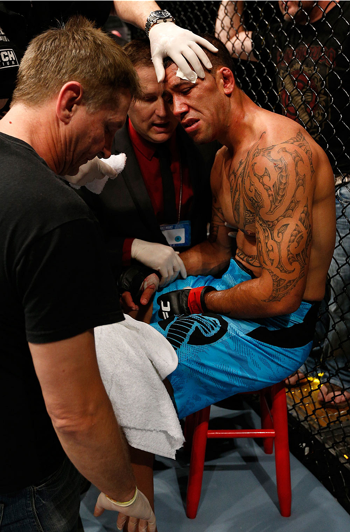 BRISBANE, AUSTRALIA - DECEMBER 07: Dylan Andrews is treated by a doctor in his corner after suffering a shoulder injury during round two of his middleweight fight against Clint Hester during the UFC Fight Night event at the Brisbane Entertainment Centre