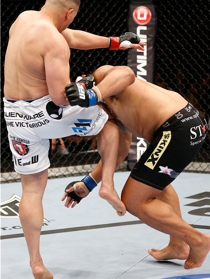 BRISBANE, AUSTRALIA - DECEMBER 07: (L-R) Pat Barry knees Soa Palelei in their heavyweight fight during the UFC Fight Night event at the Brisbane Entertainment Centre on December 7, 2013 in Brisbane, Australia. (Photo by Josh Hedges/Zuffa LLC/Zuffa LLC vi