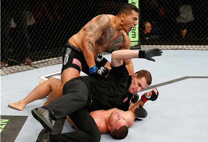 BRISBANE, AUSTRALIA - DECEMBER 07: Soa Palelei (top) defeats Pat Barry by TKO in their heavyweight fight during the UFC Fight Night event at the Brisbane Entertainment Centre on December 7, 2013 in Brisbane, Australia. (Photo by Josh Hedges/Zuffa LLC/Zuf