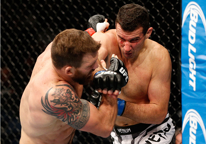 BRISBANE, AUSTRALIA - DECEMBER 07: (R-L) Anthony Perosh punches Ryan Bader in their light heavyweight fight during the UFC Fight Night event at the Brisbane Entertainment Centre on December 7, 2013 in Brisbane, Australia. (Photo by Josh Hedges/Zuffa LLC/