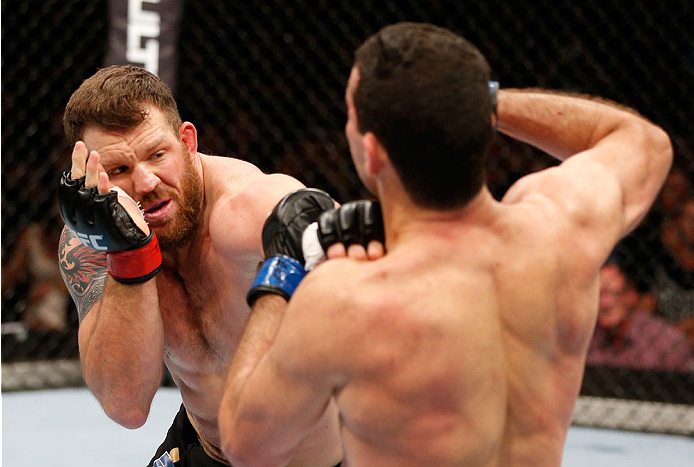 BRISBANE, AUSTRALIA - DECEMBER 07: (L-R) Ryan Bader punches Anthony Perosh in their light heavyweight fight during the UFC Fight Night event at the Brisbane Entertainment Centre on December 7, 2013 in Brisbane, Australia. (Photo by Josh Hedges/Zuffa LLC/