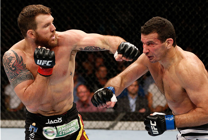 BRISBANE, AUSTRALIA - DECEMBER 07: (L-R) Ryan Bader punches Anthony Perosh in their light heavyweight fight during the UFC Fight Night event at the Brisbane Entertainment Centre on December 7, 2013 in Brisbane, Australia. (Photo by Josh Hedges/Zuffa LLC/