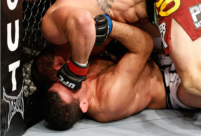 BRISBANE, AUSTRALIA - DECEMBER 07: Ryan Bader (top) punches Anthony Perosh in their light heavyweight fight during the UFC Fight Night event at the Brisbane Entertainment Centre on December 7, 2013 in Brisbane, Australia. (Photo by Josh Hedges/Zuffa LLC