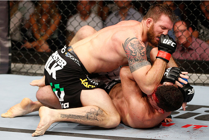 BRISBANE, AUSTRALIA - DECEMBER 07: (L-R) Ryan Bader elbows Anthony Perosh in their light heavyweight fight during the UFC Fight Night event at the Brisbane Entertainment Centre on December 7, 2013 in Brisbane, Australia. (Photo by Josh Hedges/Zuffa LLC/Z
