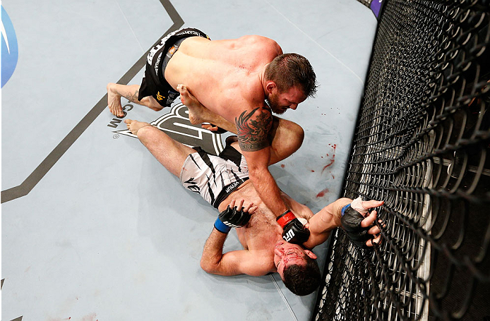 BRISBANE, AUSTRALIA - DECEMBER 07: (L-R) Ryan Bader punches Anthony Perosh in their light heavyweight fight during the UFC Fight Night event at the Brisbane Entertainment Centre on December 7, 2013 in Brisbane, Australia. (Photo by Josh Hedges/Zuffa LLC/