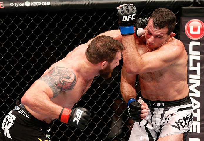 BRISBANE, AUSTRALIA - DECEMBER 07: (L-R) Ryan Bader punches Anthony Perosh in their light heavyweight fight during the UFC Fight Night event at the Brisbane Entertainment Centre on December 7, 2013 in Brisbane, Australia. (Photo by Josh Hedges/Zuffa LLC/