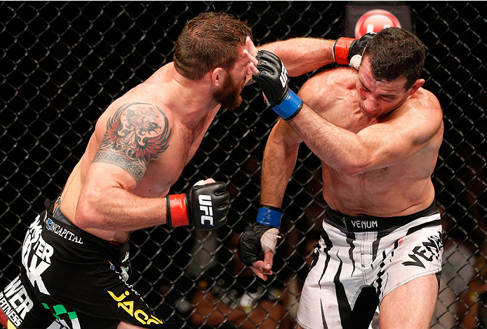 BRISBANE, AUSTRALIA - DECEMBER 07: (L-R) Ryan Bader punches Anthony Perosh in their light heavyweight fight during the UFC Fight Night event at the Brisbane Entertainment Centre on December 7, 2013 in Brisbane, Australia. (Photo by Josh Hedges/Zuffa LLC/