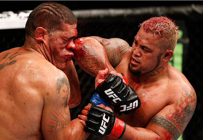 BRISBANE, AUSTRALIA - DECEMBER 07: (R-L) Mark Hunt elbows Antonio "Bigfoot" Silva in their heavyweight fight during the UFC Fight Night event at the Brisbane Entertainment Centre on December 7, 2013 in Brisbane, Australia. (Photo by Josh Hedges/Zuffa LLC
